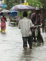 A man on the water logged street after heavy rain in Kolkata on Wednesday 05 September 2012