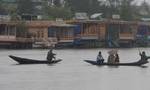 People travelling shikara at World Famous Dal Lake during a rain in Srinagar on Sunday 09, September 2012. Incessant rains continued to lash Kashmir since Saturday night, sparking crop damage fears among the farming community of the Valley.