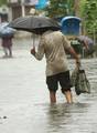 A man on the water logged street after heavy rain in Kolkata on Wednesday 05 September 2012