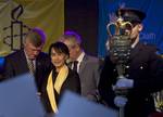 Myanmar opposition leader Aung San Suu Kyi, centre on stage during a ceremony to award her the freedom of Dublin, in Dublin, Ireland, Monday, June 18, 2012.