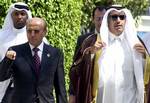 Yemeni Foreign Minister Abu Bakr Abdulla al-Kurbi, second left, gesturs as he walks in with the Qatari Foreign Minister Jassim bin Jabr Al Thani, right, accompanied by unidentified officials to attend a Arab foreign ministers meeting at the League's headquarters in Cairo, Egypt, Sunday, Aug. 20, 2006. Arab League foreign ministers convened for an emergency meeting on Sunday to discuss how to fund reconstruction in war-ravaged Lebanon and defuse Mideast tensions amid rising discord between modera