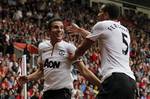 Manchester United's Robin Van Persie, left, celebrates his third goal against Southampton with teammate Rio Ferdinand during their English Premier League soccer match at St Mary's stadium, Southampton, England, Sunday, Sept. 2, 2012.