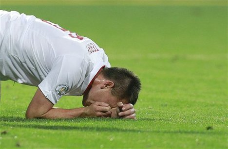 England's John Terry reacts after after an injury in Chisinau, Moldova, Friday, Sept. 7, 2012 during a Group H FIFA World Cup qualifier soccer match against Moldova.