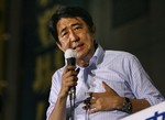  Japan&acute;s Prime Minister Shinzo Abe addresses supporters from the top of a campaign vehicle during a final day of stumping tour for Sunday&acute;s upper house election in Tokyo Saturday, July 28, 2007. Abe has alienated voters with his handling of th