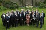 Britain's new Cabinet gather together for a group photo, in the garden of 10 Downing Street, in London, Thursday May 13, 2010, with front row left to right; Iain Duncan Smith, Liam Fox, George Osborne, William Hague, Prime Minister David Cameron, Deputy leader Nick Clegg, Sayeeda Warsi, Cheryl Gillan, Caroline Spelman, Ken Clarke, David Laws. Back rows left to right; Patrick McLoughlin, Theresa May, David Willetts, Oliver Letwin, Vince Cable, Francis Maude, Eric Pickles, Tom Strathclyde, Andrew