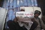 An anti-government protester reads a newspaper near Tahrir Square in Cairo, Egypt, Monday, Feb. 7, 2011. The protests, which saw tens of thousands of people massing daily in downtown Cairo for demonstrations that at times turned violent, have raised questions about the impact on the economy. More than 160,000 foreign tourists fled the country in a matter of days last week, in an exodus sure to hammer the vital tourism sector. The arabic on the newspaper headline reads 