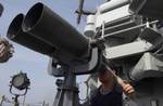 An officer aboard the HMAS Melbourne (FFG 05) looks through the ships binoculars (big eyes) while on bridge watch in Gulf of Oman, March 21, 2004. The Australian ship was participating in a Multilateral Undersea Warfare (USW) exercise conducted in the U.