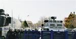 Riot police stand by as members of a leftist labor union stage a protest against the U.S. near the U.S. embassy in Ankara, Turkey, Tuesday, April 3, 2012. Demonstrators accused the U.S. of alleged support for the 1980 military coup in Turkey, a day before a trial begins against the coup leader Kenan Evren.