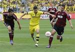 Nuremberg's Per Nilsson, right, and Timm Klose, left, and Dortmund's Robert Lewandowski challenge for the ball during the German first division Bundesliga soccer match between 1. FC Nuremberg and Borussia Dortmund in Nuremberg, Germany, Saturday, Sept.1, 2012.