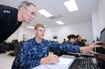 A Sailor demonstrates to Chief of Naval Personnel Vice Adm. Scott R. Van Buskirk how his computer responds to his method of problem-solving in the experimental computer-based teaching program, Digital Tutor.