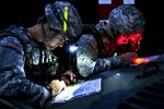 Captain Nick Franck, representing the 12th Combat Aviation Brigade, left, and 2nd Lt. Charles Smith, representing the 18th Engineer Brigade plot their points on maps for the day-to-night land navigaton course during the US Army Europe Best Junior Officer Competition Company grade officers from units through the US Army in Europe compete in the first annual Best Junior Officer Competition at the Joint Multinational Training Center which is the U.S.Army's only forward-deployed training command. Th