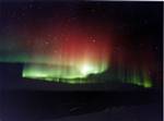 Red and green Aurora in Fairbanks, Alaska Its southern counterpart, the aurora australis or the southern polar lights, has similar properties, but is only visible from high southern latitudes in Antarctica, South America, or Australasia