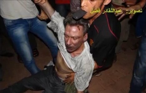 This still image included in a video obtained by the Associated Press from Fahd al-Bakoush, a freelance videographer and activist, which has been authenticated based on its contents and other AP reporting, shows the body of U.S. Ambassador Chris Stevens being moved by Libyan civilians trying to rescue him after gunmen and protesters rampaged through the U.S. consulate in Benghazi, Libya, Tuesday, Sept. 11, 2012. The group of Libyans had stumbled across Stevens' seemingly lifeless form inside a dark room and didn't know who he was, only that he was a foreigner, al-Bakoush and two other witnesses told the AP.