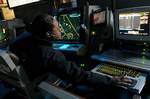 Air Traffic Controller 2nd Class Petty Officer Alisa Barnes of Mobile, Ala., monitors both the Approach A and Approach ISIS consoles in the Carrier Air Traffic Control Center (CATCC) aboard USS Theodore Roosevelt (CVN 71).