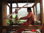 A woman weaving with a manual loom.In general, weaving involves the interlacing of two sets of threads at right angles to each other: