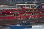 Left to right, atop barge: (grouped at left) Prince Philip, Duke of Edinburgh; Prince William, Duke of Cambridge; Catherine, Duchess of Cambridge; Prince Harry; Queen Elizabeth II; (grouped at right) Camilla, Duchess of Cornwall; Charles, Prince of Wales, aboard the MV Spirit of Chartwell during the Thames Diamond Jubilee Pageant