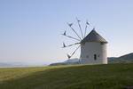 The windmill on Shodoshima Olive Park is presented to Shōdo Island from Milos.