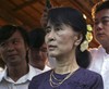 Myanmar opposition leader Aung San Suu Kyi looks at a photo during the opening ceremony of a photo exhibition entitled "Aung San Suu Kyi, The Burmese Way to Democracy" at Institute of French in Yangon, Myanmar, Thursday, May 17, 2012.