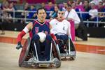 U.S. Navy retired William Groulx, U.S. Wheelchair Rugby Captain, rolls in to score a point against the Great Britain team during a match at the basketball arena during the London Paralympic Games, Sept. 5, 2012. The Paralympic Games are a major international multi-sport event where athletes with a physical disability compete; this includes athletes with mobility disabilities, amputations, blindness, and cerebral palsy. (U.S. Air Force photo by MSgt Sean M. Worrell)