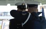 FT LAUDERDALE, Fla. (Aug. 28, 2006)--White-glove members of the Coast Guard Ceremonial Honor Guard fold the American flag during the memorial service for Petty Officer 2nd Class Steven Duque at Coast Guard Station Fort Lauderdale, Fla., August 28. The flag detail often slips three brass shell-casing into the folded flag before presenting the flag to the family. Each casing represents one volley fired during the 21-gun salute. Petty Officer Duque died in the line of duty during dive operations in