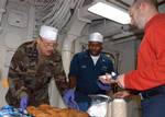 Machinist's Mate 1st Class Ernest Chandler and Machinist's Mate First Class Kelvin Buie serve cookies during the ice-cream social.