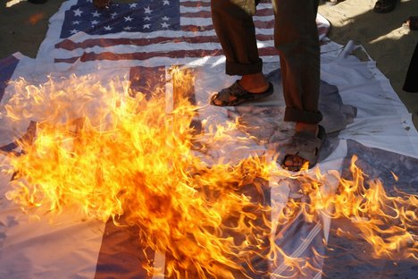 Palestinian Salafis "al-Qaeda" burning U.S. and Israeli flags as they burn image of U.S. President Barack Obama during a protest against what they said was a film being produced in the U.S. that was insulting to the Prophet Mohammad in Rafah in southern Gaza Strip on September 14, 2012. Palestinians Salafis "al-Qaeda" supporters staged demonstration in both the occupied West Bank and Gaza Strip on Friday to denounce the film, burning U.S. and Israeli flags and clashing with police in Jerusalem.Photo by Ahmed Deeb / WN