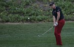 England's Ian Poulter plays a ball on the 11th green during the first round of the Abu Dhabi Golf Championships in Abu Dhabi, United Arab Emirates, Thursday, Jan. 20, 2011.