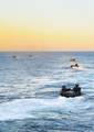 Amphibious assault vehicles assigned to Battalion Landing Team (BLT) 1/2 debark from the well deck of the amphibious transport dock ship USS New York (LPD 21) for a beach raid exercise.