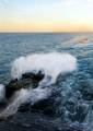 Amphibious assault vehicles assigned to Battalion Landing Team (BLT) 1/2 debark from the well deck of the amphibious transport dock ship USS New York (LPD 21) for a beach raid exercise.