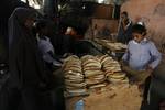 A Palestinians bake bread at a traditional bakery in the Palestinian Rafah refugee camp, in the southern Gaza Strip on September 24, 2012. 