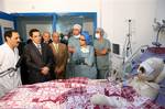 In this image released by the Tunisian Presidency office, showing Tunisian President Zine El Abidine Ben Ali, 2nd left, as he visits Mohamed Bouazizi, the young man from Sidi Bouzid who set fire to himself before being rescued and taken to intensive care at the Ben Arous Burn and Trauma Centre, in Tunis, Tuesday, Dec. 28, 2010. Unemployed 26-year old man Mohamed Bouazizi tried to commit suicide on Dec. 17, an event which triggered many days of violent protests against the high rate of youth unem