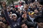 Tunisian protestors shout slogans in front of the RCD party office after the sign bearing its name was dismantled, in Tunis, Thursday, Jan. 20. 2011. The Constitutional Democratic Rally, RCD, party was founded by ousted President Zine El Abidine Ben Ali, who fled to Saudi Arabia on Friday after 23 years in power.