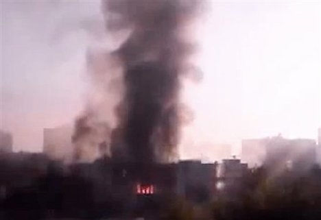 In this image taken from video obtained from the Syria 2011 Archives, which has been authenticated based on its contents and other AP reporting, black smoke rises from Syria's army command headquarters in Damascus, Syria, on Wednesday, Sept. 26, 2012.