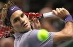 Roger Federer of Switzerland returns the ball to Richard Gasquet of France during their match of the Paris Tennis Masters tournament