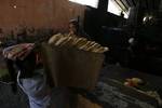 A Palestinians bake bread at a traditional bakery in the Palestinian Rafah refugee camp, in the southern Gaza Strip on September 24, 2012. 