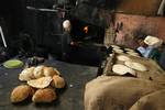 A Palestinians bake bread at a traditional bakery in the Palestinian Rafah refugee camp, in the southern Gaza Strip on September 24, 2012. 