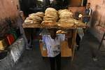 A Palestinians bake bread at a traditional bakery in the Palestinian Rafah refugee camp, in the southern Gaza Strip on September 24, 2012. 