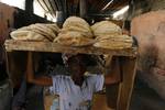 A Palestinians bake bread at a traditional bakery in the Palestinian Rafah refugee camp, in the southern Gaza Strip on September 24, 2012. 