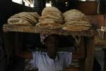 A Palestinians bake bread at a traditional bakery in the Palestinian Rafah refugee camp, in the southern Gaza Strip on September 24, 2012. 