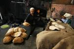 A Palestinians bake bread at a traditional bakery in the Palestinian Rafah refugee camp, in the southern Gaza Strip on September 24, 2012. 