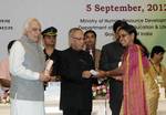 The President, Shri Pranab Mukherjee presenting the National Award for Teacher-2011 to Smt. B Govinadamma, Andhra Pradesh, on the occasion of the �Teachers Day�, in New Delhi on September 05, 2012. The Union Minister for Human Resource Development and Communications and Information Technology, Shri Kapil Sibal is also seen.