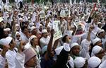 Members of various hard line Islamic shout during a demonstration calling for an Islamic sect, known as Ahmadiyah, to be disbanded Monday, June 9, 2008 in Jakarta, Indonesia. More than 5,000 demonstrators gathered outside Indonesia's presidential palace to demand that the government outlaw the moderate Muslim sect they consider heretica