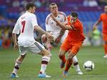 Robin van Persie from the Netherlands, right, and Denmark's Daniel Agger, center, vie for the ball as Denmark's William Kvist looks on, during the Euro 2012 soccer championship Group B match between the Netherlands and Denmark in Kharkiv, Ukraine, Saturday, June 9, 2012.