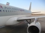 Qatar Airways A320 at the airport.  Kuwait International Airport can currently handle more than seven million passengers a year.