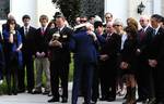 CLEARWATER, Fla. Capt. John Turner, commanding officer of Air Station Clearwater, receives an embrace from Inge Spatuzzi, during her husband's funeral ceremony at St. Cecelia's Catholic Church in Clearwater Fla., Jan. 21, 2012. Coast Guard Lt. j.g. Frank Spatuzzi died Jan. 13, at Suncoast Hospice House in Brookside, Fla., after his health declined from a fall he suffered Dec. 24, 2011. He was 93. U.S. Coast Guard photo by Petty Officer 3rd Class Michael De Nyse. (1503221) ( )