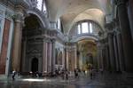 Frigidarium of Baths of Diocletian, today Santa Maria degli Angeli. Tile covered concrete quickly supplanted marble as the primary building material and more daring buildings soon followed, with great pillars supporting broad arches and domes rather than dense lines of columns suspending flat architraves