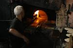 A Palestinians bake bread at a traditional bakery in the Palestinian Rafah refugee camp, in the southern Gaza Strip on September 24, 2012. 