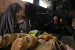 A Palestinians bake bread at a traditional bakery in the Palestinian Rafah refugee camp, in the southern Gaza Strip on September 24, 2012. 