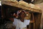 A Palestinians bake bread at a traditional bakery in the Palestinian Rafah refugee camp, in the southern Gaza Strip on September 24, 2012. 