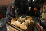 A Palestinians bake bread at a traditional bakery in the Palestinian Rafah refugee camp, in the southern Gaza Strip on September 24, 2012. 